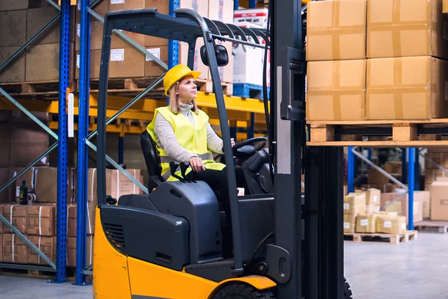 Electric forklift in a warehouse